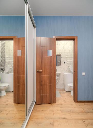 a bathroom with two doors and two sinks and toilets at Блакитна студия, Південний вокзал 5 хвилин in Kharkiv