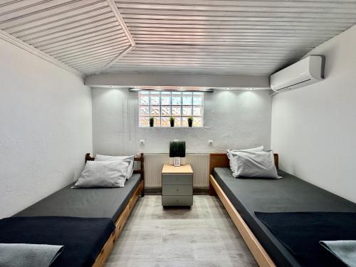 a room with two beds and a tv in it at Four Seasons - The White Queen House in Kriopigi