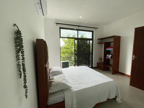 a bedroom with a bed and a large window at Stylish 1-Bedroom Apartments with Amazing Views in Dar es Salaam