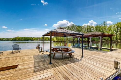 a wooden deck with a picnic table and a pavilion at Plum Paradise in Glenora