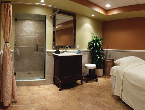 a bedroom with a shower and a bed and a sink at Safety Harbor Resort & Spa Trademark Collection by Wyndham in Safety Harbor