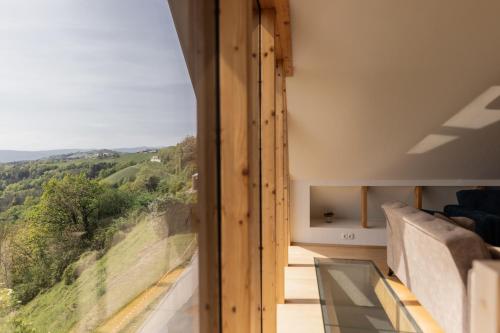 a room with a view of the mountains from a house at Winzerhaus Römerstrasse in Kitzeck im Sausal