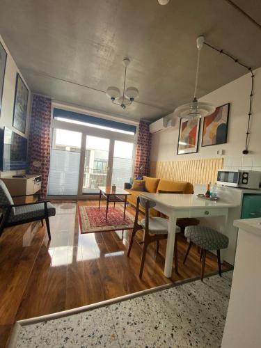 a living room with a table and a couch at Lux Lotnisko in Wrocław