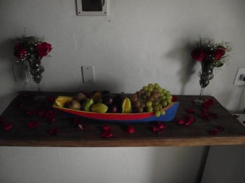 a bowl of fruit sitting on a table at Pousada Mar & Vida e Doçaria in Paraty