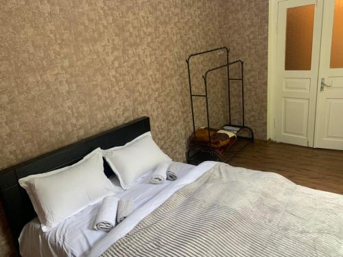 sypialnia z dużym łóżkiem z białą pościelą i poduszkami w obiekcie Villa Bodbe w mieście Sighnaghi
