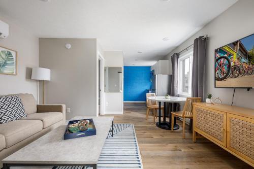 a living room with a couch and a table at Downtown Newly Remodeled Apartment AC Beach Restaurants Breweries Nightlife in Traverse City