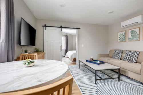 a living room with a table and a couch at Downtown Newly Remodeled Apartment AC Beach Restaurants Breweries Nightlife in Traverse City