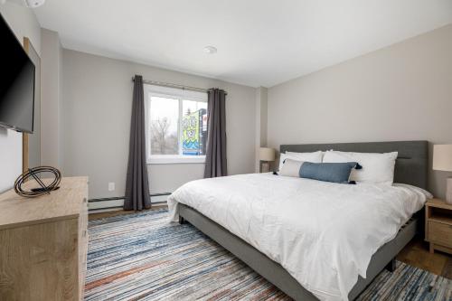 a bedroom with a large bed and a window at Large Apt Downtown AC Beach Shops Walk in Traverse City