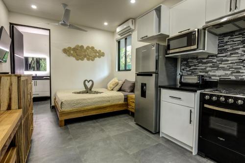 a small kitchen with a bed in a room at Villa Colibri - Private 1 bedroom Studio/Bachelor in Punta Uva
