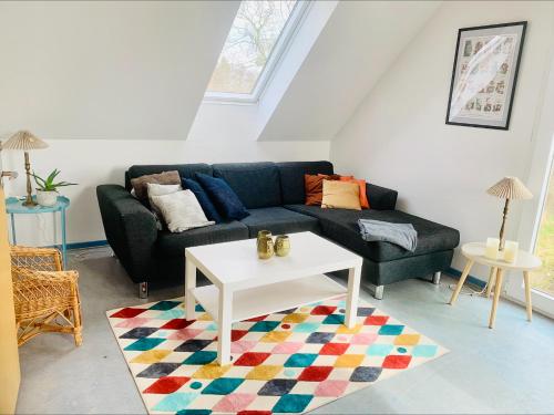 a living room with a couch and a table at Kongshøjgaard in Farsø