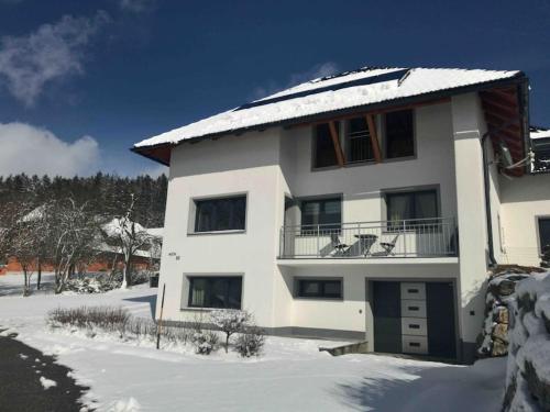 a white house with snow on the roof at Haus im Grünen in Bad Zell