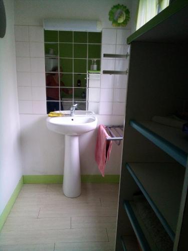 a bathroom with a sink and a mirror and a tub at Vachement bien ! in Saint-Nicolas-de-la-Haie