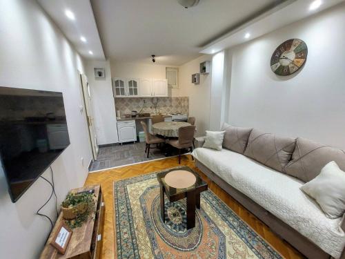 a living room with a couch and a table at Stan na dan Alexa sa free parkingom in Novi Sad