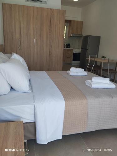 a bedroom with a large bed with two pillows on it at Votsalo Studios & Apartment in Frangokastello