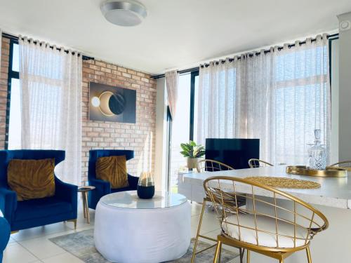 a living room with a white table and chairs at DEE-LOFT 53 in Windhoek