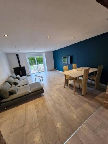a living room with a table and a dining room at Maison de village in Vesoul