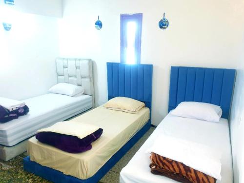 two beds in a room with blue and white at CASA dreams Chaouen in Chefchaouene