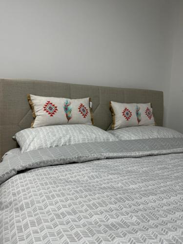 a bed with two pillows on top of it at Your Room in Sarajevo