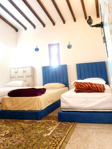 two beds in a room with blue dividers at CASA dreams Chaouen in Chefchaouene