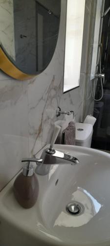 a bathroom with a sink with a mirror and a sink at Coral Reef Apartments in St. Paul's Bay