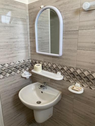 a bathroom with a sink and a mirror at Barbarous in Ajim