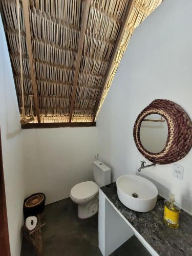 a bathroom with a white toilet and a sink at Pousada Velho Bateau in Atins