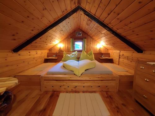 a bed in a wooden room in a cabin at Almhuette Auszeit in Donnersbachwald