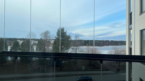 een uitzicht op een meer vanuit het raam van een gebouw bij Casa Emerald, laadukas kaksio saunalla, wifi, matkakeskus 280 m, juna ja bussiasema in Kajaani