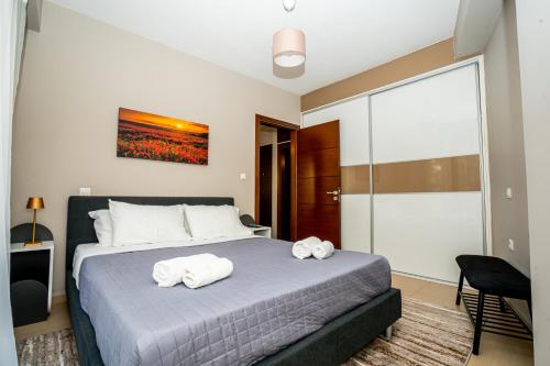 a bedroom with a bed with two towels on it at Ioannina city center - Michelangelo Apartments - A1 in Ioannina