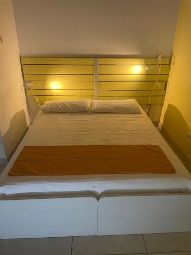 a bedroom with a large bed with a wooden headboard at B&B Le Albare in Montecchia di Crosara