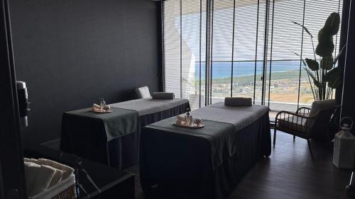 a room with two beds and a large window at 2 Bedroom Amazing sea view Grand Sapphire in Iskele