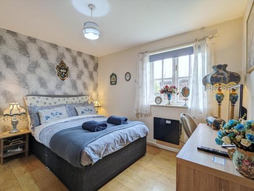 a bedroom with a bed and a desk and a window at City Centre Vintage Theme Guest Rooms in Liverpool