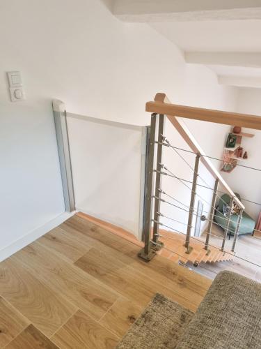 a staircase in a room with a wooden floor at 4 stars by the sea - wifi - parking - Clim in Le Lavandou