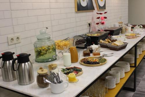a kitchen counter with a buffet of food on it at Hotel Citizen Avlabari in Tbilisi City