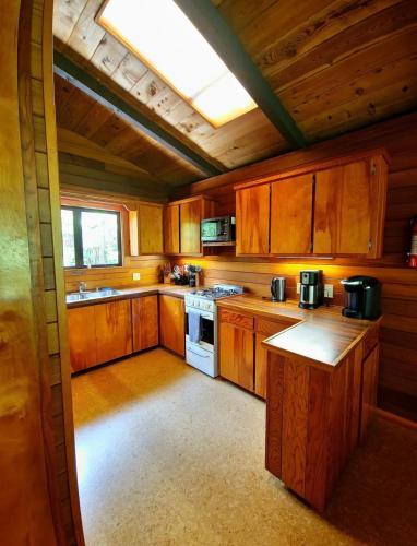 a large kitchen with wooden cabinets and a skylight at The Pacifica Inn in Volcano