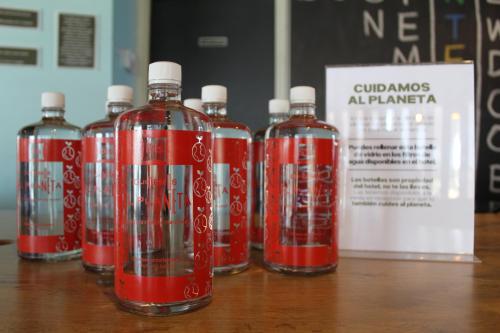 a group of red bottles sitting on top of a table at Ibis Culiacan in Culiacán