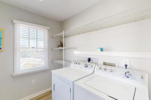 a white laundry room with a washer and dryer at Conch #4A-CAC in Buxton