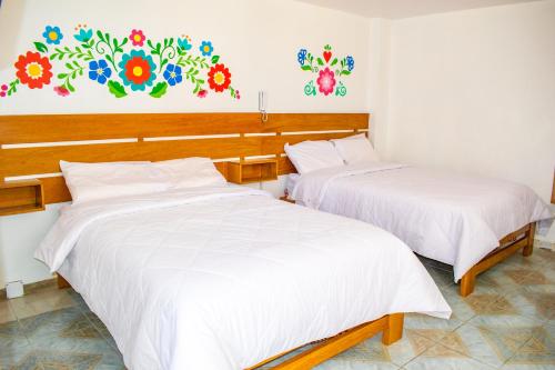 Una cama o camas en una habitación de Hospedaje Perlaschallay