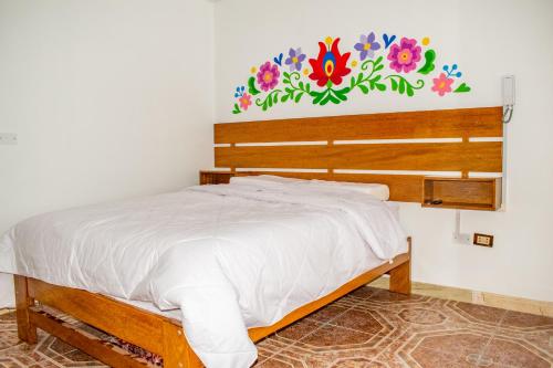 Una cama o camas en una habitación de Hospedaje Perlaschallay
