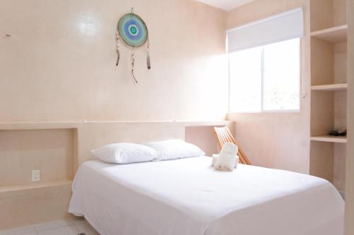 a bedroom with a bed with a frisbee on the wall at Kin Tulum Apartamentos in Tulum