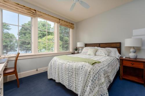 a bedroom with a bed and a desk and windows at Private Pool & Lake MI access, hot tub, putting green, basketball court, and more! in Fennville
