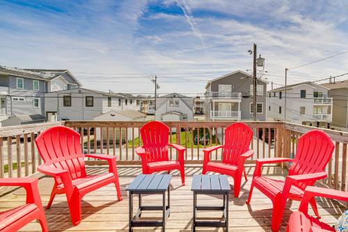 a group of red chairs sitting on a deck at Family Friendly Ocean City Condo Steps to Beach! in Ocean City
