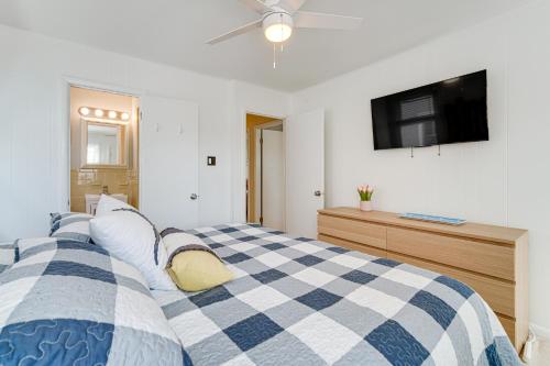 a bedroom with a blue and white checkered bed at Family Friendly Ocean City Condo Steps to Beach! in Ocean City