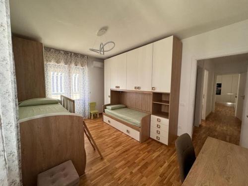 a bedroom with a bed and a desk in it at La Maison de Monique in Policoro