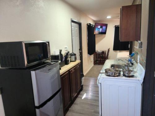 a kitchen with a microwave on top of a refrigerator at 070B Grand Canyon Suite with Kitchenette near South Rim Sleeps 4 in Valle