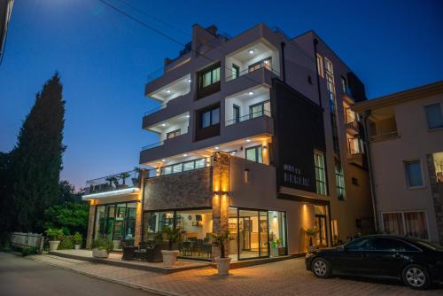 a building with a car parked in front of it at Premium Berlin with Pool in Ulcinj