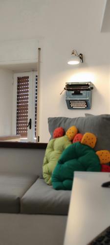 a couch with colorful pillows on it in a living room at Casa Vacanza - La Tartaruga in Milazzo
