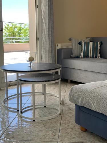 a living room with a table and a couch at Stellar Dreams in Kavala