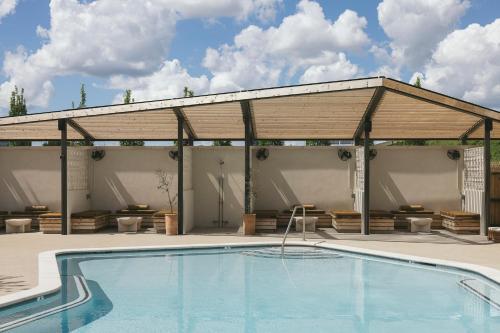 a pavilion with a swimming pool in front of a house at Drift Nashville, a Member of Design Hotels in Nashville