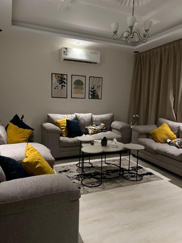 a living room with couches and a table at شقه غرفه وصاله مودرن مع دخول ذاتي in Riyadh